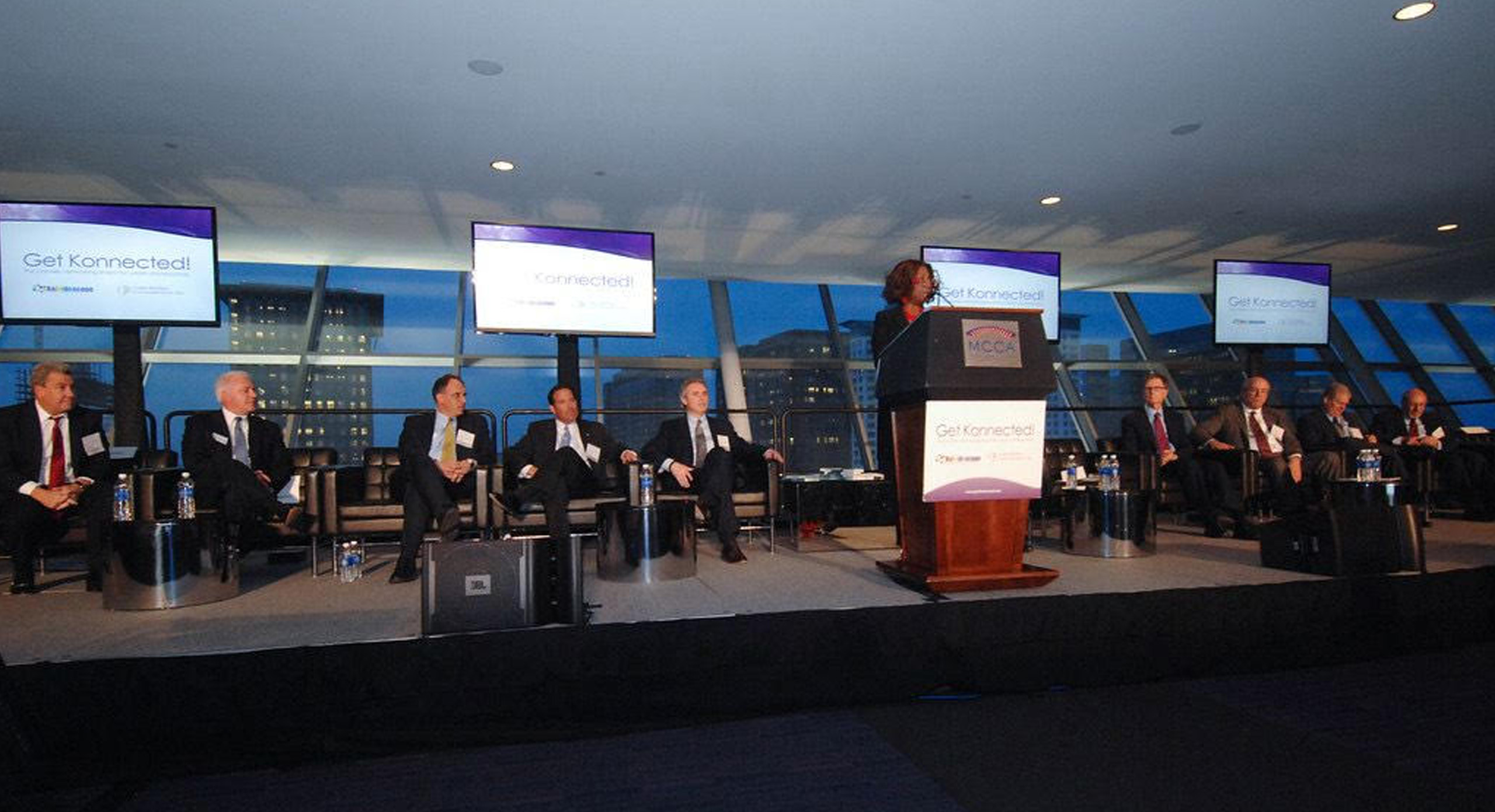 Collete Phillips standing in front of a panel discussing Get Konnected